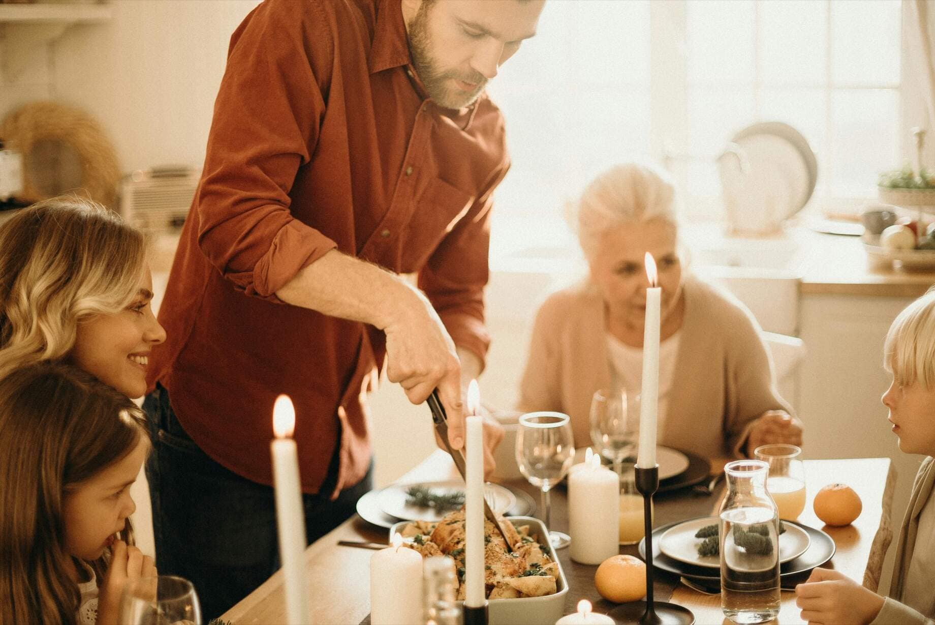 Three generations sharing a candlelit family dinner