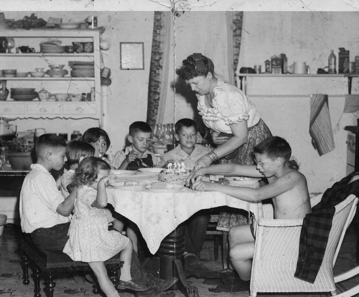Archival photo of the family gathered around the dinner table