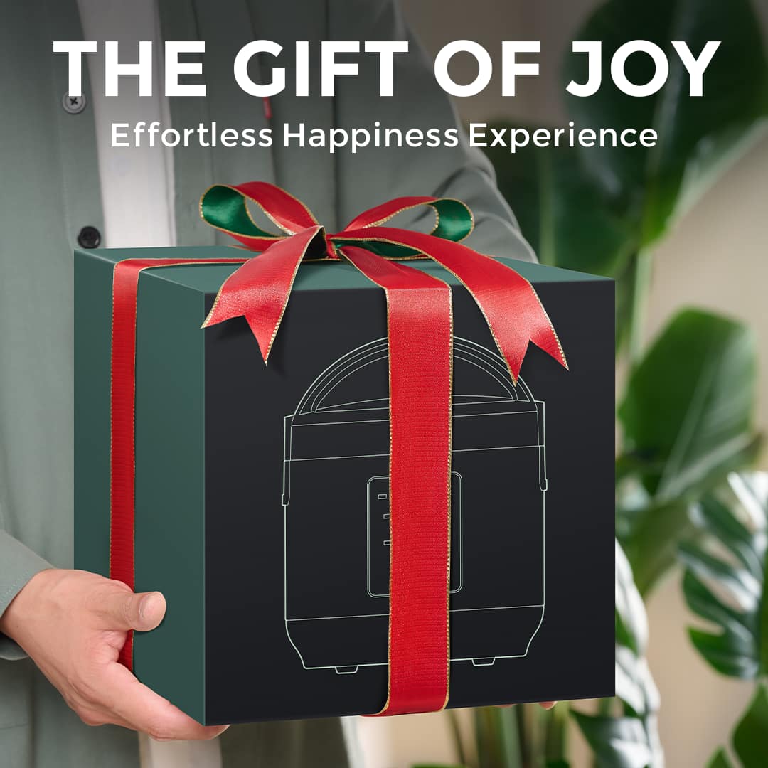 Dark ÉCRU gift box tied with a red ribbon, held in two hands