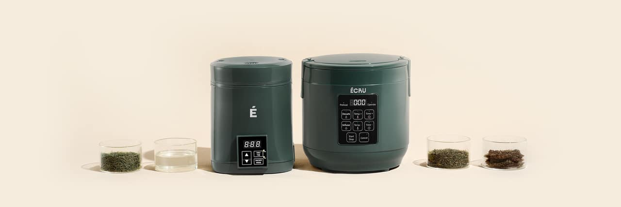 The 2oz unit with its canister, lids, and bowls of herb arranged on a cream surface