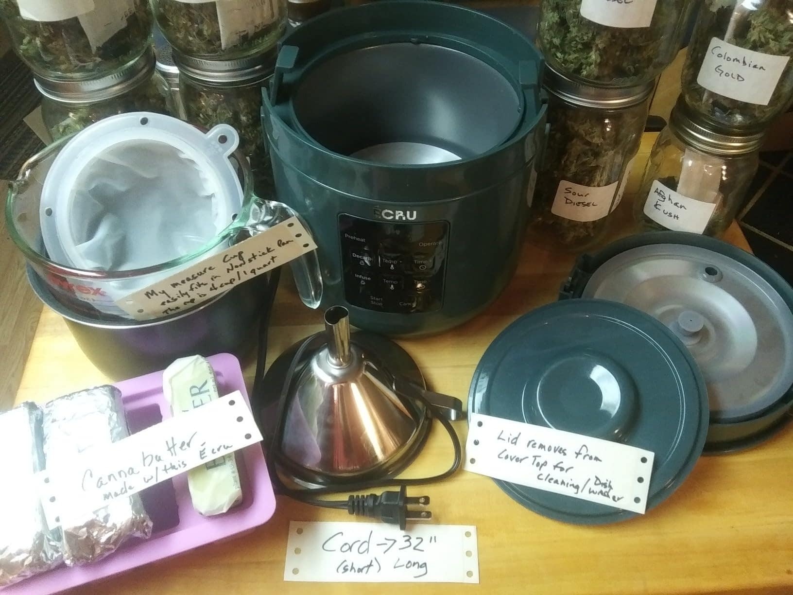 Customer photo: decarboxylator surrounded by jars of dried herbs and finished cannabutter