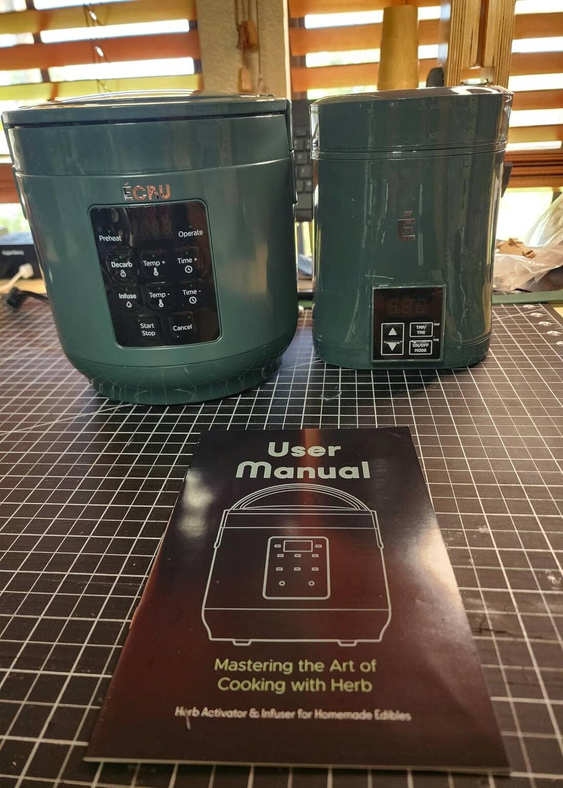 Customer photo: two ÉCRU units with the user manual on a cutting mat