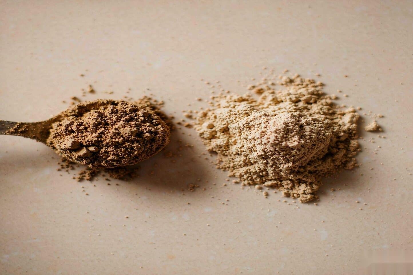 Compacted kief clump beside loose, broken-up kief powder