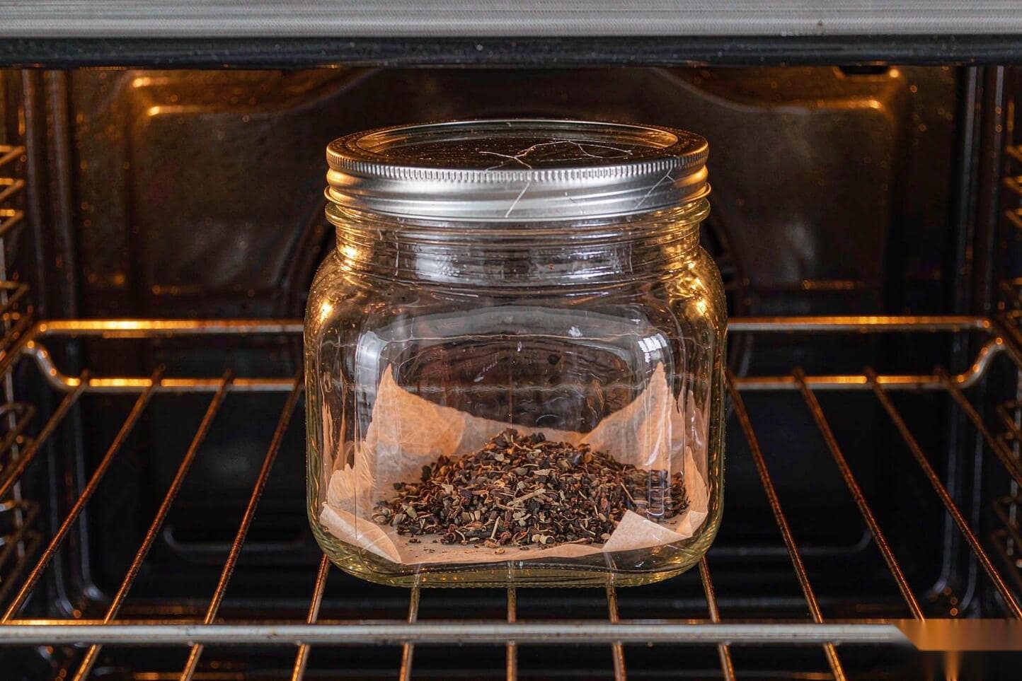 Mason jar with parchment and ground flower on an oven rack
